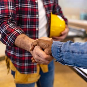 Person shaking hands with a bathroom remodeling contractor.